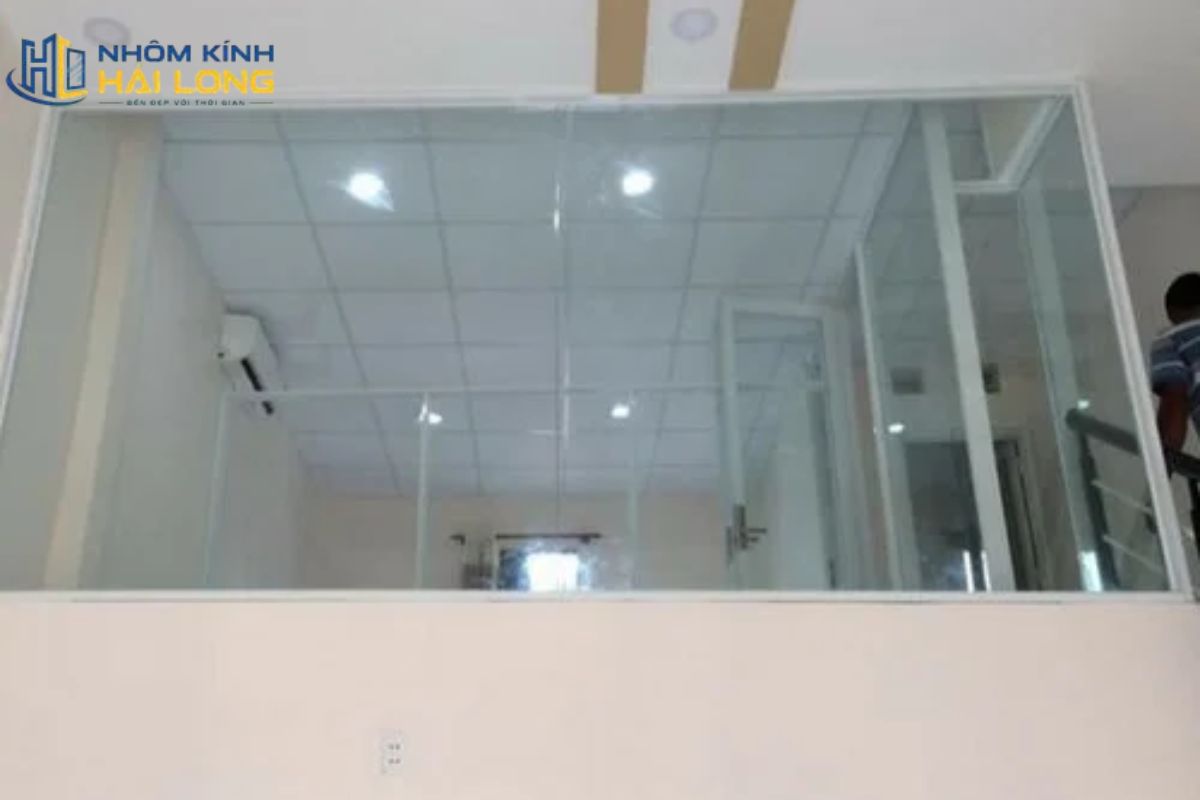 Một bộ vách nhôm kính gác lửng hoàn chỉnh gồm khung nhôm, kính, gioăng, keo, vật tư liên kết và phụ kiện cửa phù hợp tải trọng